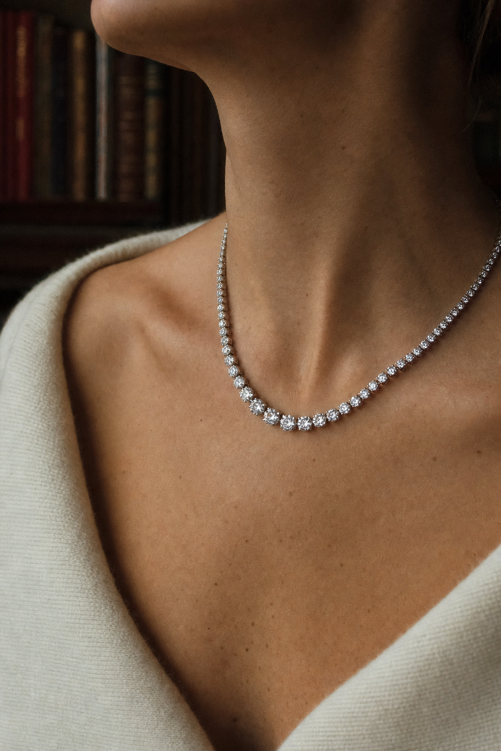 editorial portrait — woman in cream cashmere with diamond tennis necklace